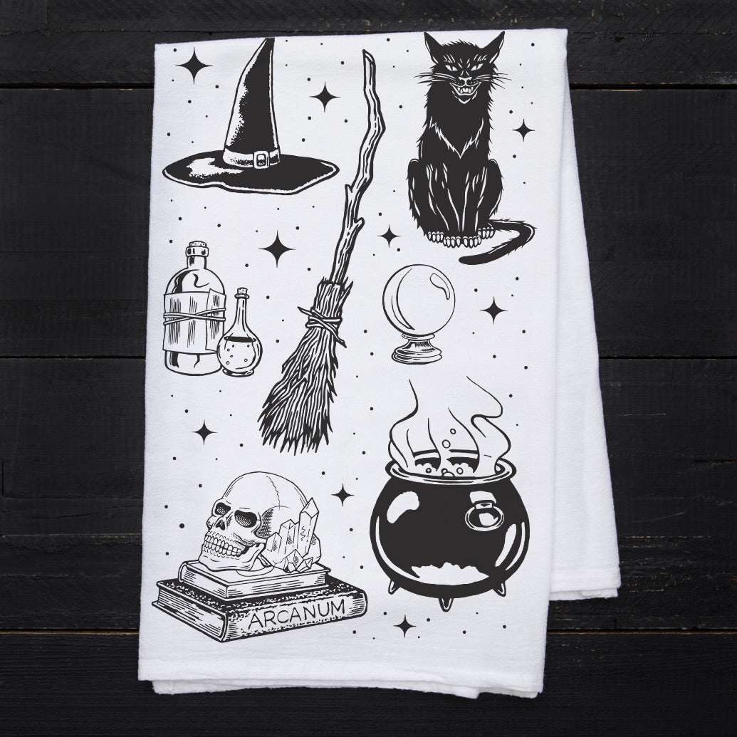 a tea towel with a witch themed design on it