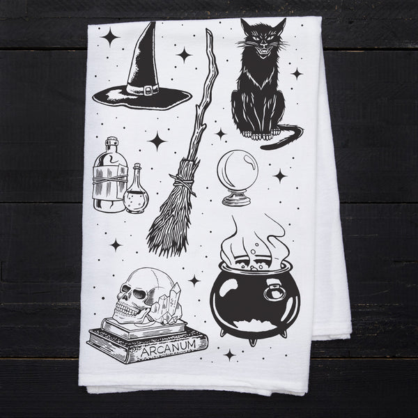 a tea towel with a witch themed design on it