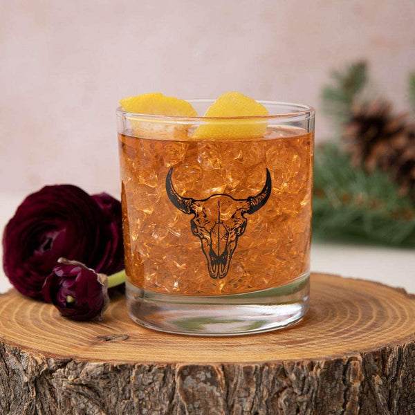 Hand-drawn buffalo skull illustration screen printed onto a whiskey glass.