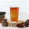 a glass of beer sitting on top of a table
