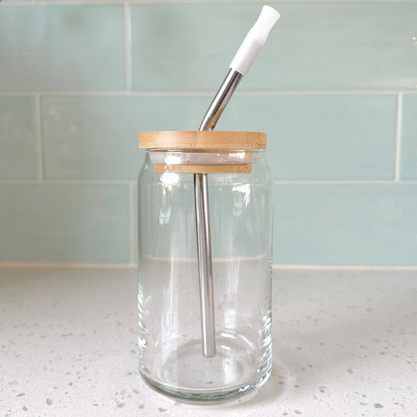Bamboo lid with a stainless steel straw on a clear glass jar, showcasing eco-friendly sipping solutions by Counter Couture.