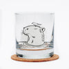 Capybara Rocks Glass featuring a black outline of a capybara with a bird on its head, displayed on a cork coaster.