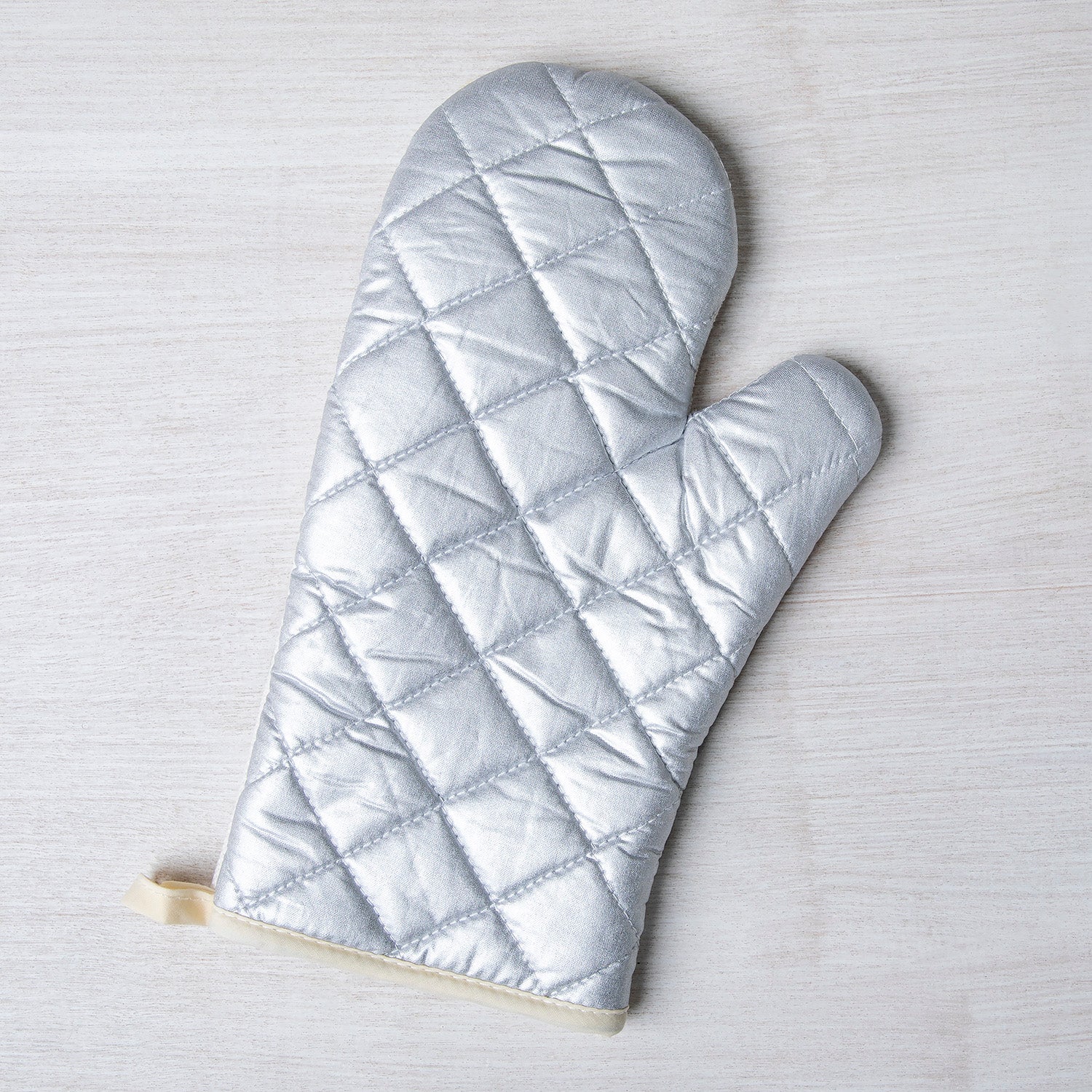 Stylish Highland Cow Oven Mitt from Counter Couture with silver quilted heat-resistant backing.