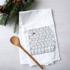 Counter Couture Santa Cats flour sack towel featuring a playful design of rows of cats with one wearing a red Santa hat, surrounded by pinecones and greenery.