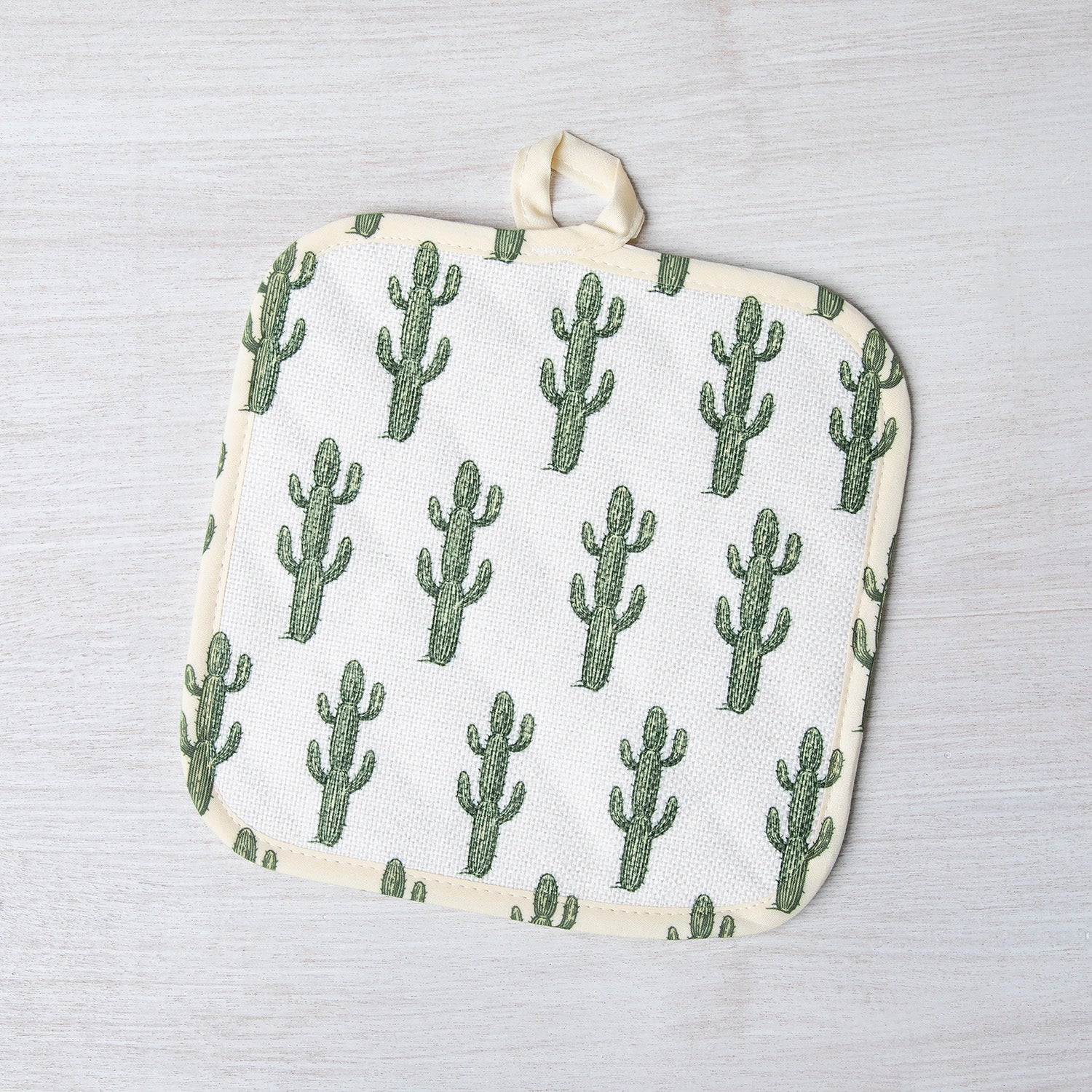 Saguaro Pot Holder showcased in a vibrant kitchen setting, highlighting its unique heat-resistant design and beautiful cactus motif.