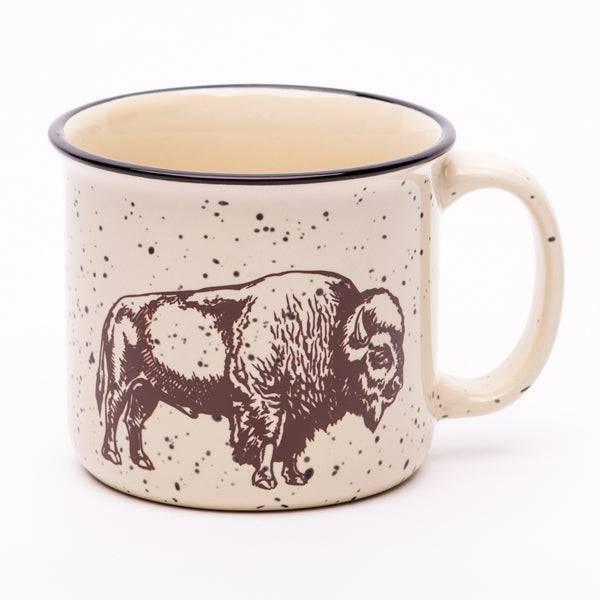 Cream-colored speckled ceramic mug with a black rim, featuring a hand-drawn illustration of a bison on the side.