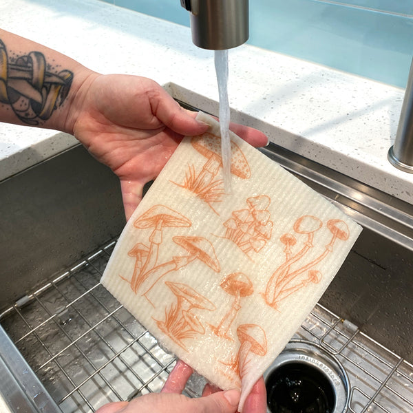Mushroom Swedish Dish Cloth in action, demonstrating its absorbent quality for efficient cleaning.