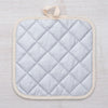 Sasquatch Pot Holder hanging with convenient fabric loop, showcasing its heat-resistant backing and playful design.