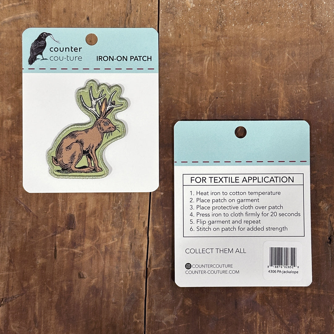 two patches, one of a deer and one of a rabbit, both labeled as iron-on patches.