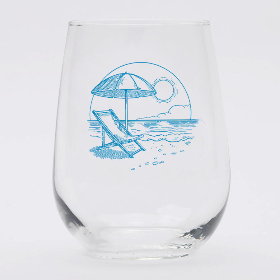 a wine glass with a drawing of a beach chair and umbrella
