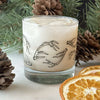 A rocks glass filled with a white drink and ice is printed with black hand-drawn antlers. Rocks Glass