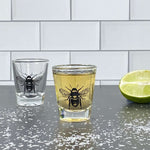 Bee skull shot glass with tequila, lime, and salt on countertop