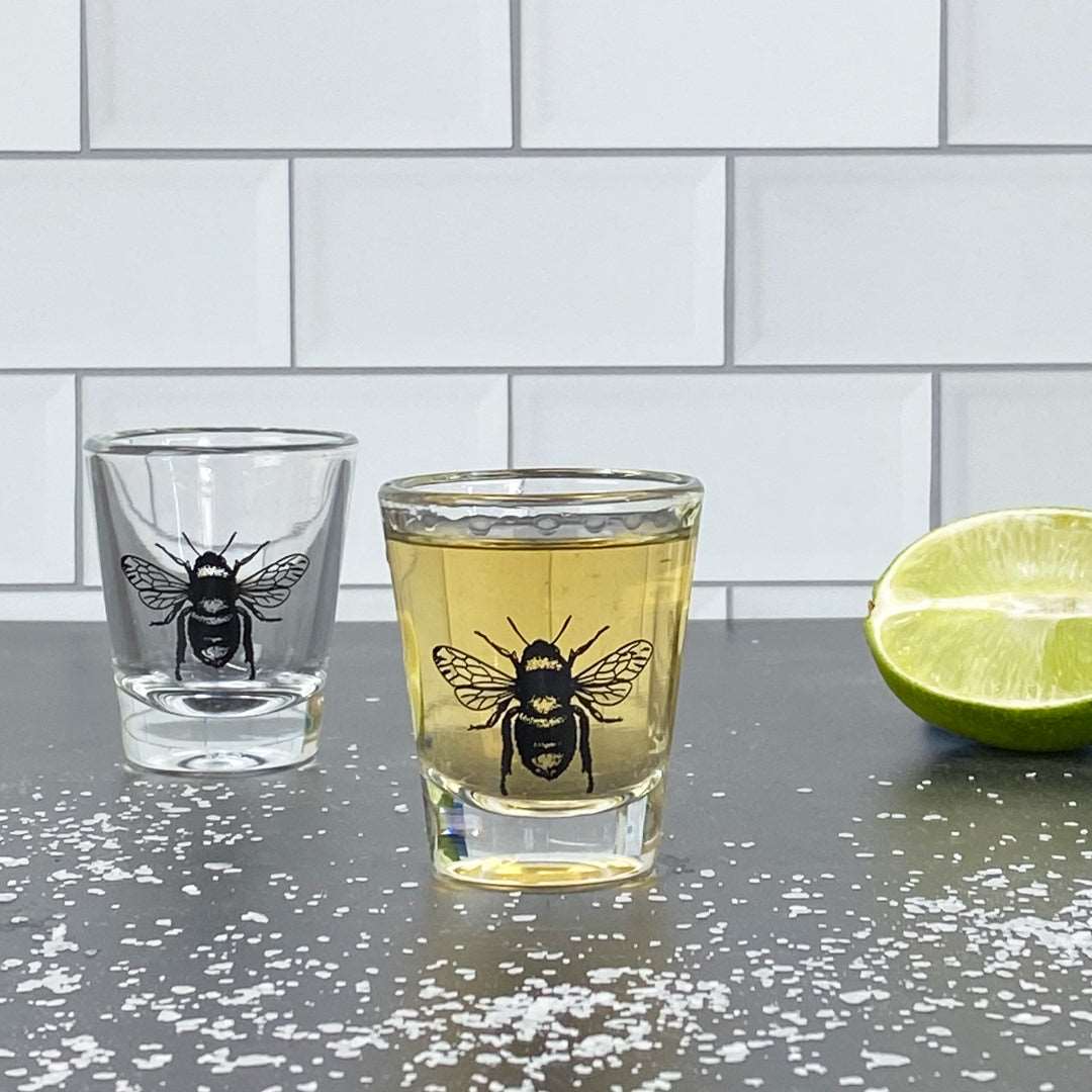 Bee skull shot glass with tequila, lime, and salt on countertop