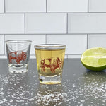 Bison print shot glass filled with liquor, lime half, and salt on a modern bar counter