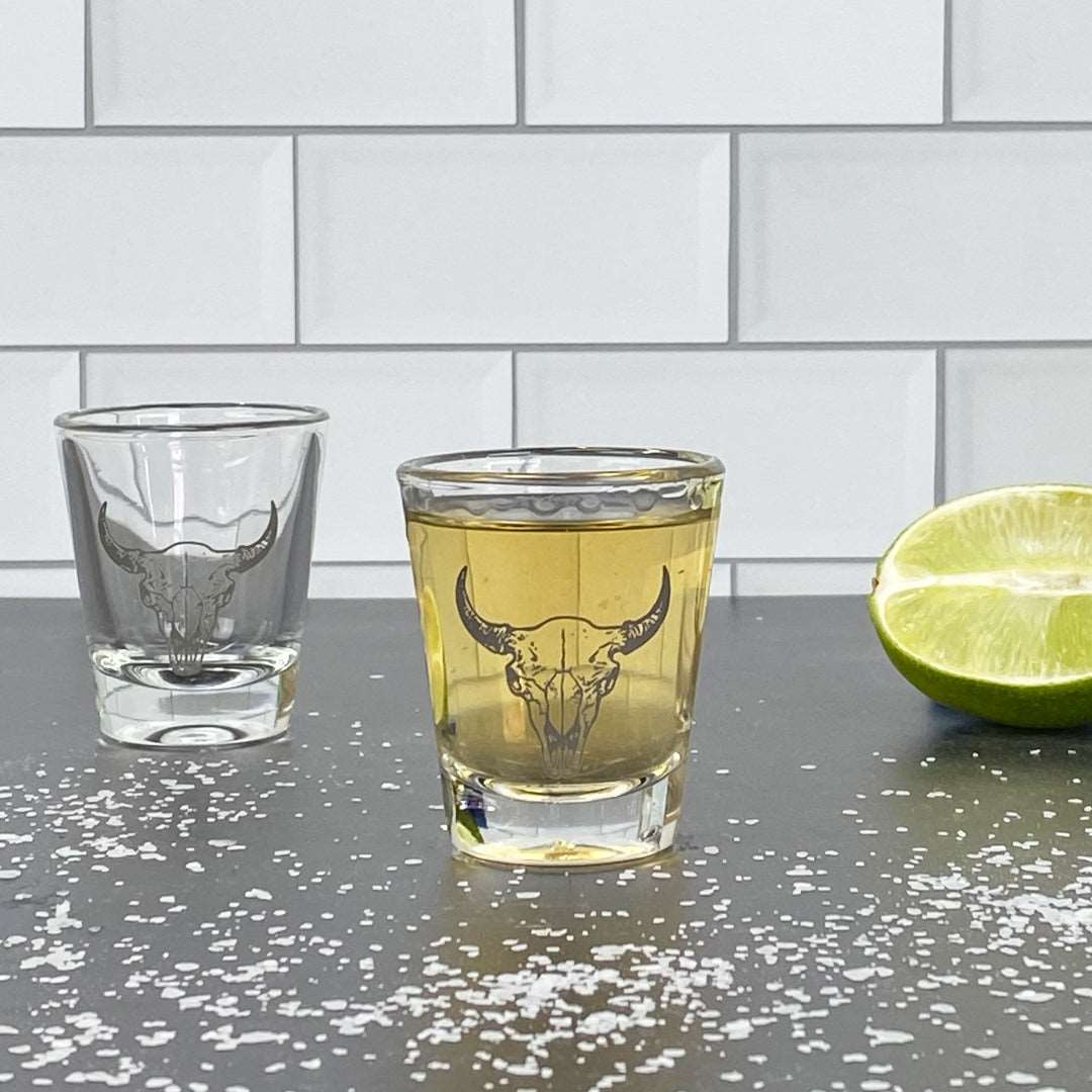 Buffalo skull shot glass on bar counter with tequila, lime, and salt