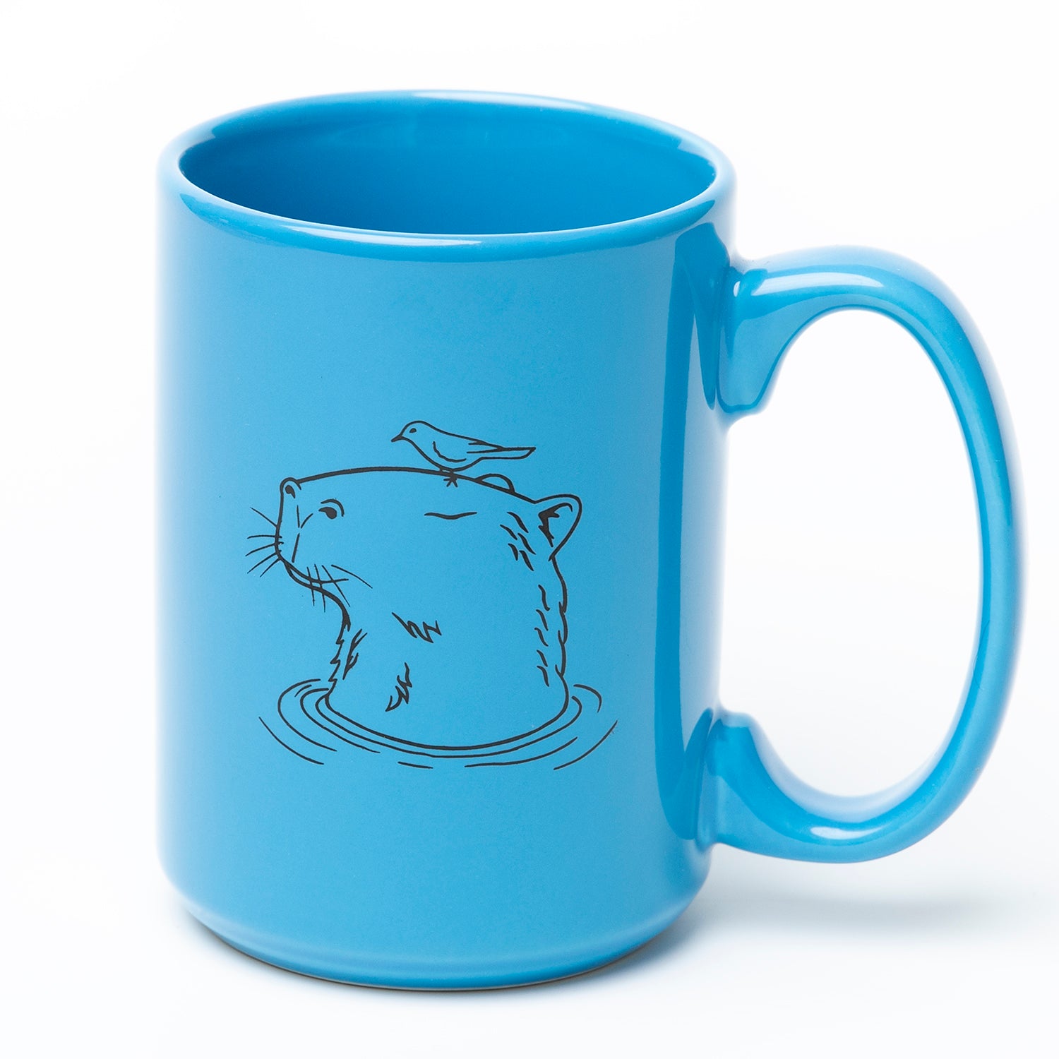 Blue ceramic mug with a line art capybara and bird illustration, novelty drinkware.