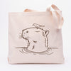 Capybara canvas tote bag from Counter Couture featuring a cute illustration of a capybara with a bird perched on its head, perfect for shopping or grocery trips.
