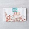 Desert-themed flour sack tea towel with cactus and roadrunner illustration on white cotton.
