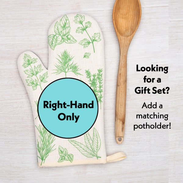 Herb print oven mitt for right hand with green botanical design, wooden spoon beside it
