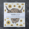 Bright and cheerful Highland Cow Swedish Dishcloth by Counter Couture, designed to make cleaning enjoyable and sustainable.