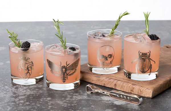 Halloween Rocks glassware featuring, skull, moth, heart, and a beetle.