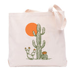 Saguaro tote bag featuring a fun cactus design with a bright orange sun, perfect for eco-friendly shopping and carrying groceries, made by Counter Couture.