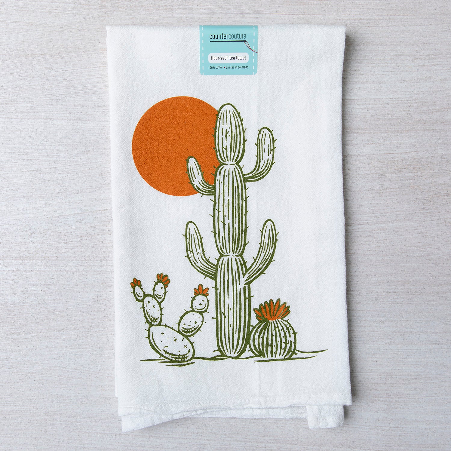 a towel with a cactus and a sun on it