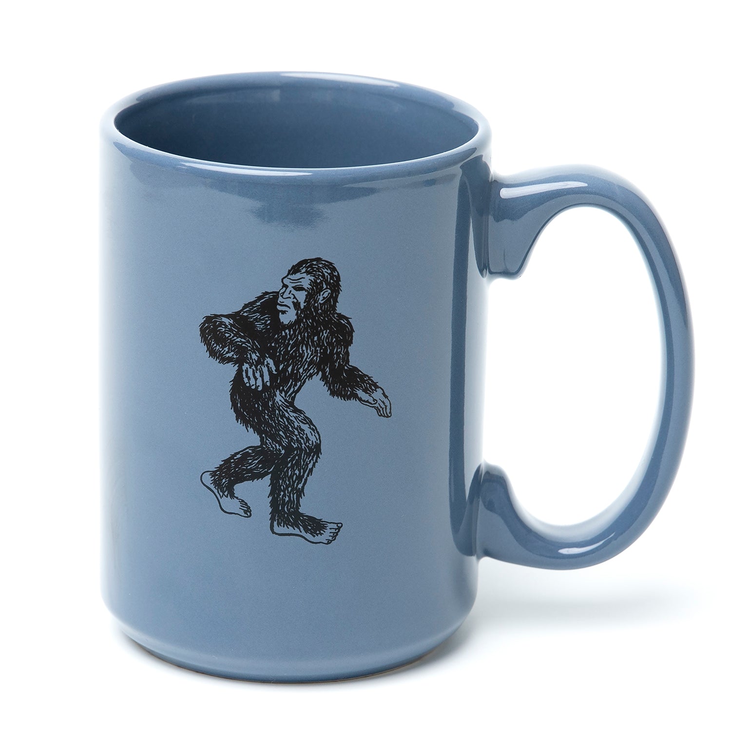 Blue ceramic mug with black Sasquatch illustration on the side.