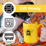 Dog licking a yellow bee mug, gift ready, dishwasher safe, made in USA, oven cured print.