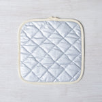 Close-up of the Saguaro Pot Holder fabric, featuring its stylish cactus patterns and convenient fabric loop for easy hanging.