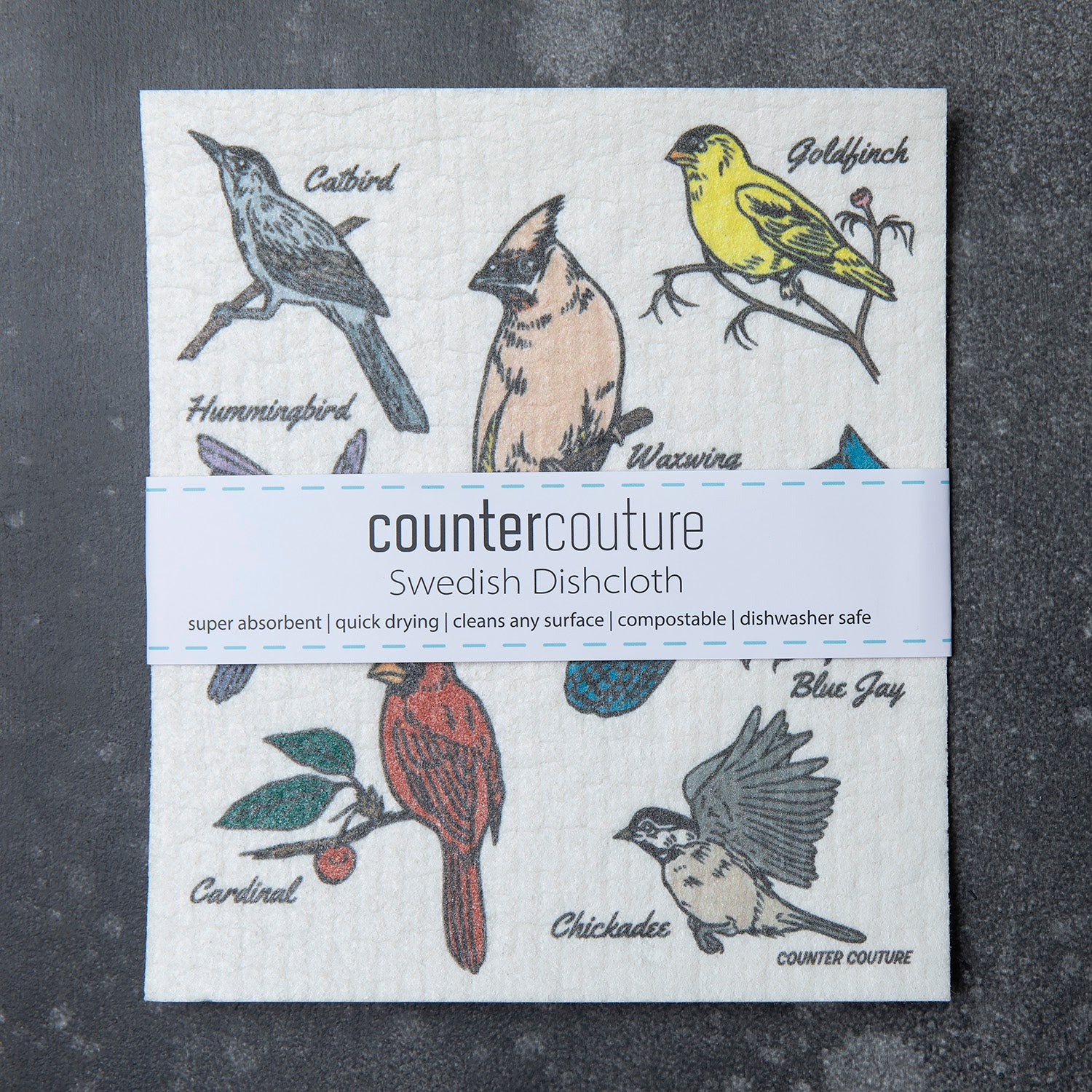 Swedish dishcloth from Counter Couture, showcasing colorful bird designs with a packaging label highlighting its features: super absorbent, quick-drying, and compostable.