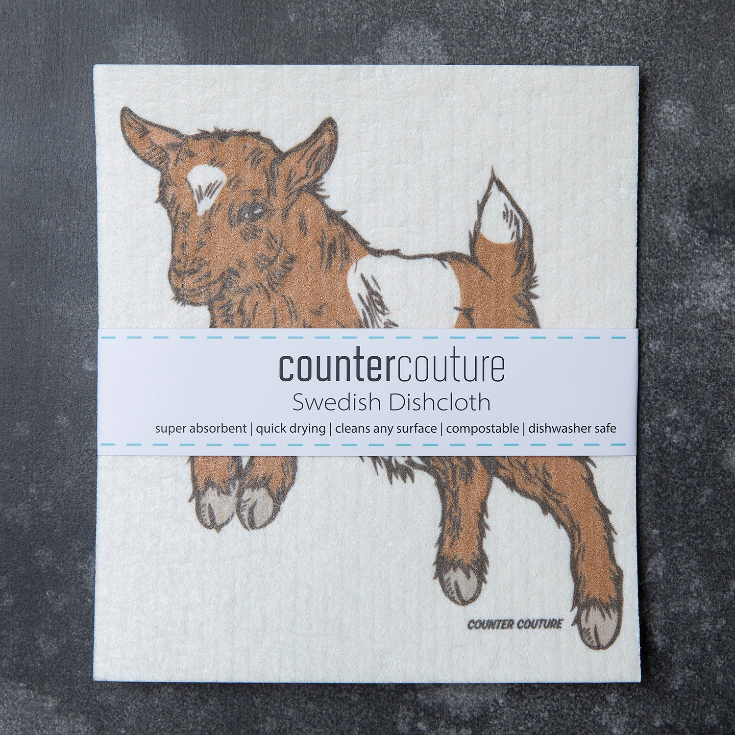 Counter Couture Baby Goat Swedish Dish Cloth in action, perfect for cleaning tasks while adding a touch of fun to your kitchen.