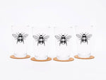 Set of four pint glasses with black bee illustration, each on a cork coaster, white background