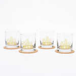 Set of four whiskey glasses with yellow cactus design on cork coasters, white background