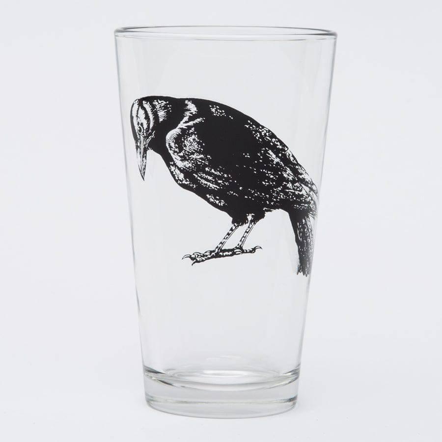 Pint glass with black crow illustration, unique barware on white background