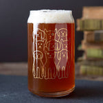 Beer can glass with cute gold dog illustrations, filled with amber beer on table