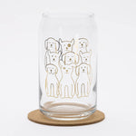 Clear can-shaped drinking glass with playful dog illustrations, ideal for fun barware.