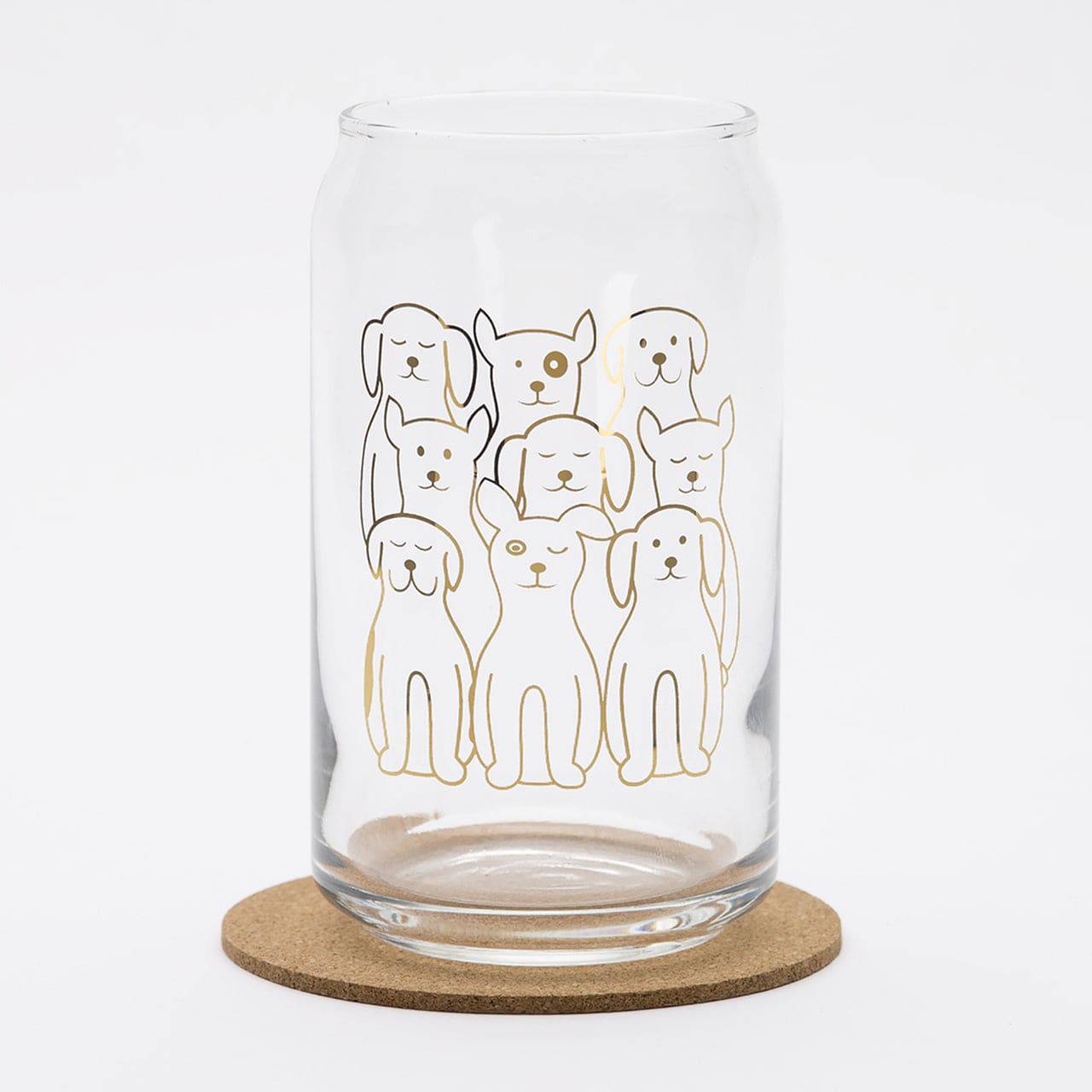 Clear can-shaped drinking glass with playful dog illustrations, ideal for fun barware.