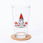 Pint glass with gnome and red mushroom illustration, whimsical barware on cork coaster