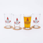Set of four pint glasses with gnome and mushroom illustrations, one filled with beer