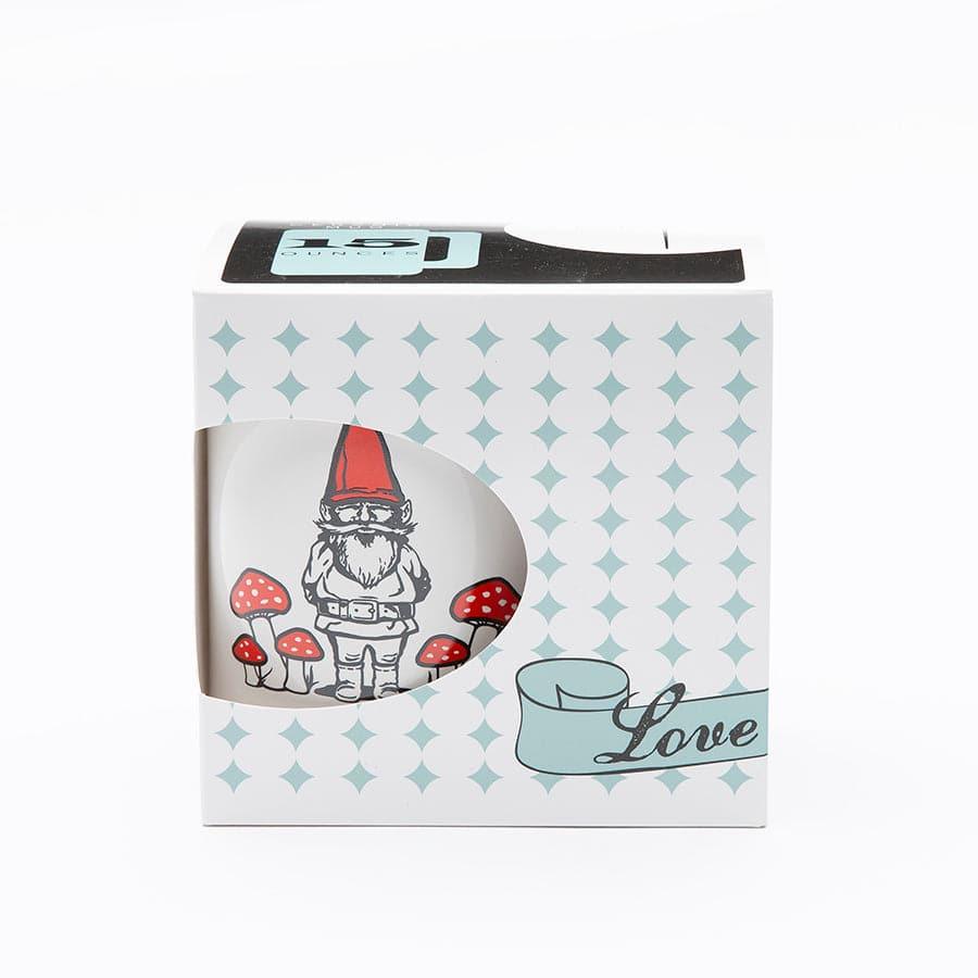 Gift boxed mug featuring a gnome with red hat and mushrooms, visible through window packaging