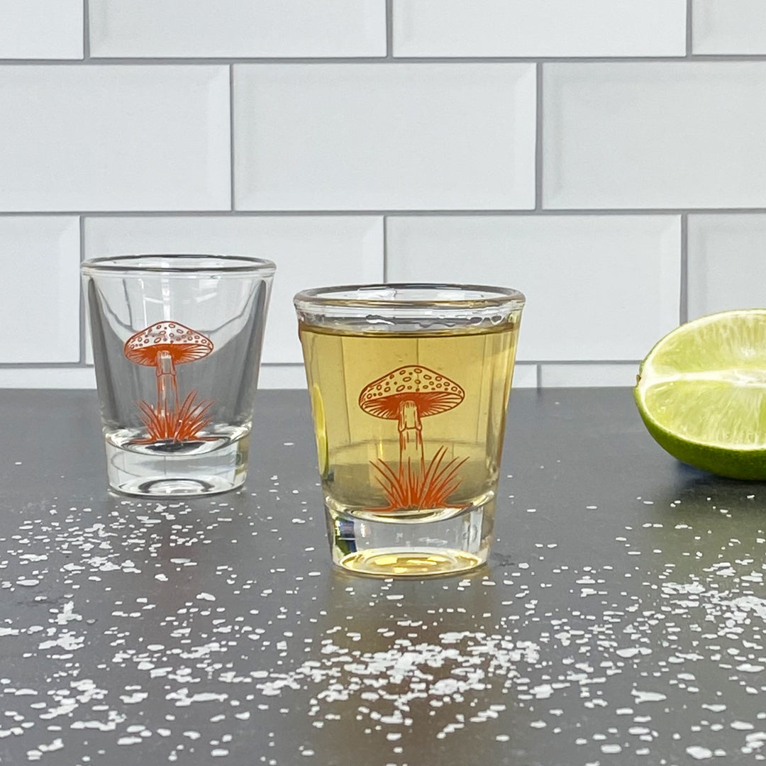 Mushroom skull shot glass on kitchen counter with lime wedge and salt, barware photography