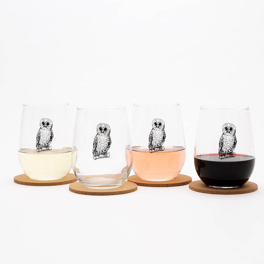 Set of four stemless wine glasses with black owl illustrations, each on a cork coaster