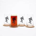 Set of four clear can-shaped beer glasses with black Sasquatch design on cork coasters
