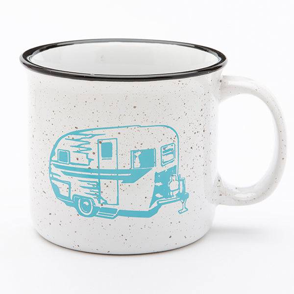 White ceramic mug with black rim and blue vintage trailer graphic, speckled design
